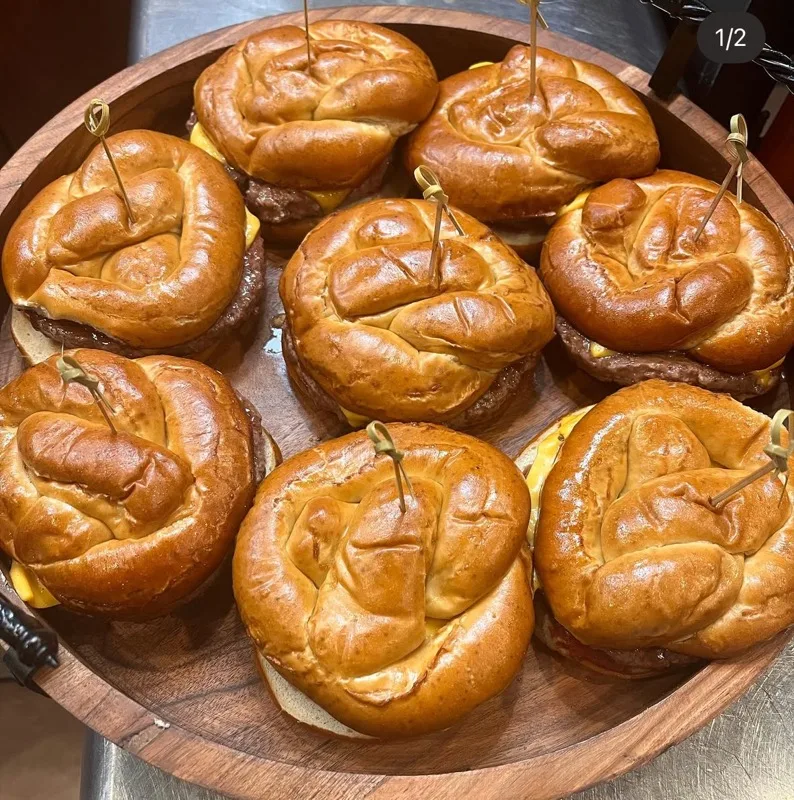 Tray of pretzel bun cheeseburger sliders